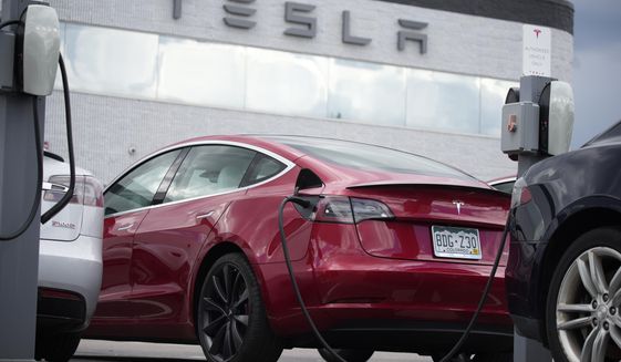 A 2021 Model 3 sedan is connected to a charger at a Tesla dealership on June 27, 2021, in Littleton, Colo. The National Highway Traffic Safety Administration said Thursday, June 9, 2022, that it&#39;s upgrading the probe into an engineering analysis, another sign of increased scrutiny of the electric vehicle maker and automated systems that perform at least some driving tasks. (AP Photo/David Zalubowski, File)