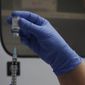 FILE - A vial of the Phase 3 Novavax coronavirus vaccine is seen ready for use in the trial at St. George&#39;s University hospital in London, Oct. 7, 2020. The Novavax COVID-19 vaccine that could soon win federal approval may offer a boost for the U.S. military: an opportunity to get shots into some of the thousands of service members who have refused the vaccine for religious reasons. (AP Photo/Alastair Grant, File)