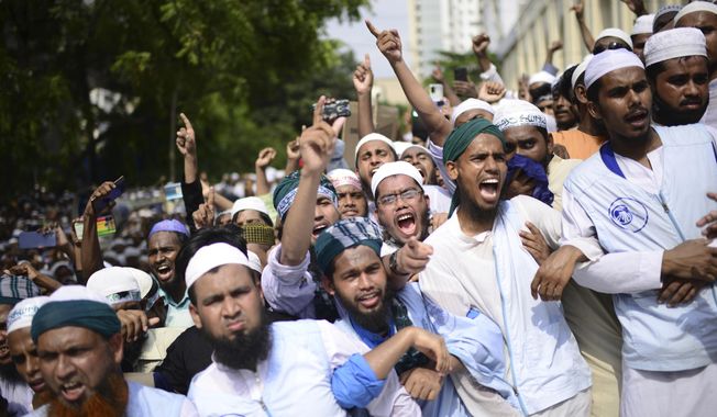 Muslims shout slogans against Nupur Sharma, a spokesperson of India&#x27;s governing Hindu nationalist party as they react to the derogatory references to Islam and the Prophet Muhammad made by her, during a protest outside a mosque in Dhaka, Bangladesh, Friday, June 10, 2022. Thousands of people marched in Bangladesh&#x27;s capital on Friday to urge Muslim-majority nations to cut off diplomatic ties with India and boycott its products unless it punishes two governing party officials for comments deemed derogatory to Islam&#x27;s Prophet Muhammad. (AP Photo/Mahmud Hossain Opu)