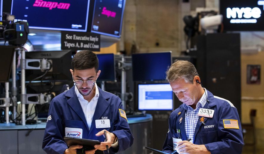 In this photo provided by the New York Stock Exchange, traders Orel Partush, left, and Robert Charmak work on the floor, Friday, June 10, 2022. Stocks on Wall Street fell sharply Friday after getting hammered by data showing inflation is getting worse, not better, as investors had been hoping. (David L. Nemec/New York Stock Exchange via AP)