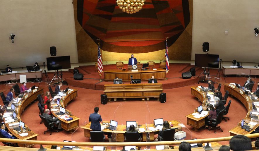 FILE -- This May 3, 2022 file photo shows members of the Hawaii House of Representatives discussing legislation at the Hawaii State Capitol in Honolulu. Hawaii lawmakers this year passed several bills to boost government transparency and promote better lawmaker behavior but their critics, and some lawmakers themselves, say they still have work to do, especially after a bribery scandal sullied the state Legislature. (AP Photo/Audrey McAvoy, File)