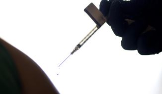A droplet falls from a syringe after a health care worker was injected with the Pfizer-BioNTech COVID-19 vaccine at Women &amp;amp; Infants Hospital in Providence, R.I., on Dec. 15, 2020. On Friday, June 10, 2022, The Associated Press reported on stories circulating online incorrectly claiming that 20,000 people have died from COVID-19 vaccines. The figure misrepresents data maintained by the Centers for Disease Control and Prevention and the Food and Drug Administration. To date, a total of nine deaths in the U.S. have been linked to the shots. (AP Photo/David Goldman, File)