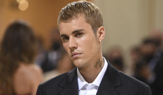 Justin Bieber attends The Metropolitan Museum of Art&#39;s Costume Institute benefit gala on Sept. 13, 2021, in New York. Bieber leads the iHeartRadio Music Award nominations. Justin Bieber says a rare disorder that paralyzed half of the superstar performer’s face is the reason behind his tour postponement. The Grammy winner said he’s suffering from Ramsey Hunt syndrome in video he posed Friday, June 10, 2022 on Instagram. The syndrome causes facial paralysis and affects nerves in the face through a shingles outbreak.(Photo by Evan Agostini/Invision/AP, File)