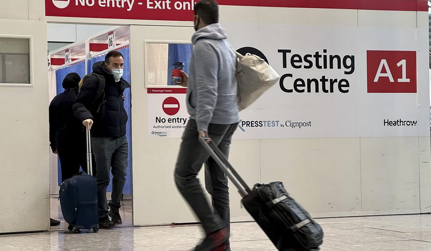 Passengers get a COVID-19 test at Heathrow Airport in London, Nov. 29, 2021, in this file photo.  The Biden administration is lifting its requirement that international air travelers to the U.S. take a COVID-19 test within a day before boarding their flights, easing one of the last remaining government mandates meant to contain the spread of the coronavirus. A senior administration official says the mandate expires Sunday at 12:01 a.m. Eastern time. The official says the Centers for Disease Control and Prevention has determined that it’s no longer necessary. (AP Photo/Frank Augstein, File)  **FILE**