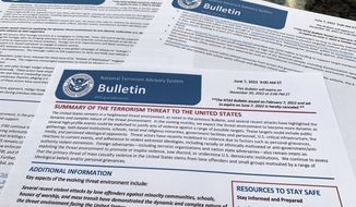 The bulletin issued by the Department of Homeland Security, outlining the current terrorism threat to the United States, is photographed Thursday, June 9, 2022. DHS warned June 7 that skewed framing of the subjects like abortion, guns, immigration and LGTBQ rights, could drive extremists to violently attack pubic places across the U.S. in the coming months. (AP Photo/Jon Elswick)