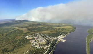 This June 10, 2022, aerial photo provided by the Bureau of Land Management Alaska Fire Service shows a tundra fire burning near the community of St. Mary&#39;s, Alaska. The largest documented wildfire burning through tundra in southwest Alaska was within miles St. Mary&#39;s and another nearby Alaska Native village, Pitkas Point, prompting officials Friday to urge residents to prepare for possible evacuation. (Ryan McPherson/Bureau of Land Management Alaska Fire Service via AP)