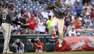 Washington Nationals&#39; Juan Soto, right, celebrates his two-run home run with third base coach Gary Disarcina (10) as he rounds the bases during the fifth inning of a baseball game against the Milwaukee Brewers, Saturday, June 11, 2022, in Washington. (AP Photo/Nick Wass)