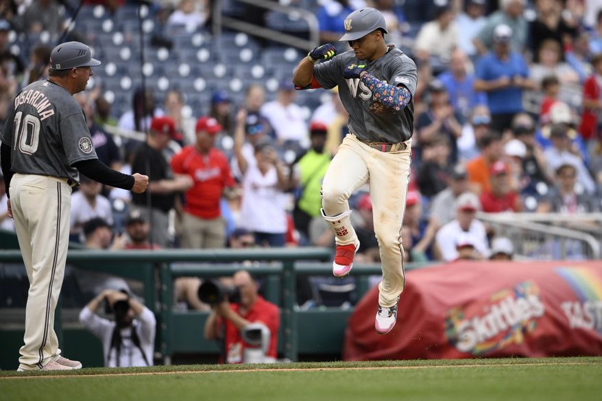 Washington Nationals&#39; Juan Soto, right, celebrates his two-run home run with third base coach Gary Disarcina (10) as he rounds the bases during the fifth inning of a baseball game against the Milwaukee Brewers, Saturday, June 11, 2022, in Washington. (AP Photo/Nick Wass)