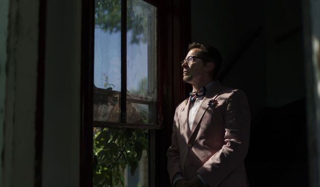 Scout, a transgender man who uses one name, stands in the entrance to his home in Providence, R.I., Wednesday, June 8, 2022. The 2020 census questionnaire drove Scout crazy. With no direct questions about sexual orientation and gender identity, it made him feel invisible, not worth including in the U.S. head count. (AP Photo/David Goldman)
