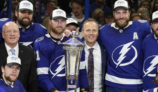 Tampa Bay Lightning center Steven Stamkos (91), head coach Jon Cooper, and defenseman Victor Hedman (77) pose with the Prince of Wales Trophy after the team defeated the New York Rangers during Game 6 of the NHL hockey Stanley Cup playoffs Eastern Conference finals Saturday, June 11, 2022, in Tampa, Fla. (AP Photo/Chris O&#x27;Meara) **FILE**