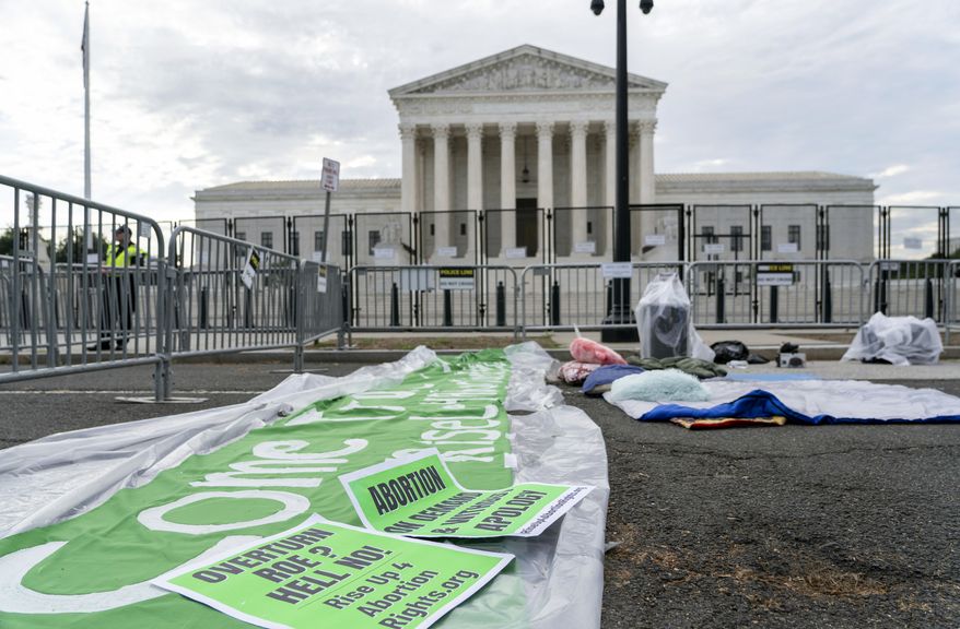 Placards supporting abortion rights are placed outside U.S Supreme Court building in Washington, Monday, June 13, 2022. (AP Photo/Gemunu Amarasinghe)
