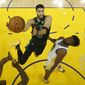 Boston Celtics forward Jayson Tatum, left, shoots against Golden State Warriors forward Andrew Wiggins during the second half of Game 5 of basketball&#39;s NBA Finals in San Francisco, Monday, June 13, 2022. (AP Photo/Jed Jacobsohn, Pool) **FILE**