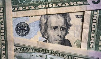 Photo of Andrew Jackson on a $20 bill is shown, Jan. 28, 2022, in Cleveland. Inflation is at a 40-year high. Stock prices are sinking. The Federal Reserve is making borrowing much costlier. Home sales are down, and mortgage rates are up. And the economy actually shrank in the first three months of this year. Is the United States at risk of enduring another recession, just two years after emerging from the last one? For now, even the more pessimistic economists don’t foresee any imminent downturn, at least not before next year. (AP Photo/Tony Dejak)