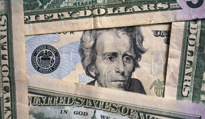 Photo of Andrew Jackson on a $20 bill is shown, Jan. 28, 2022, in Cleveland. Inflation is at a 40-year high. Stock prices are sinking. The Federal Reserve is making borrowing much costlier. Home sales are down, and mortgage rates are up. And the economy actually shrank in the first three months of this year. Is the United States at risk of enduring another recession, just two years after emerging from the last one? For now, even the more pessimistic economists don’t foresee any imminent downturn, at least not before next year. (AP Photo/Tony Dejak) ** FILE **