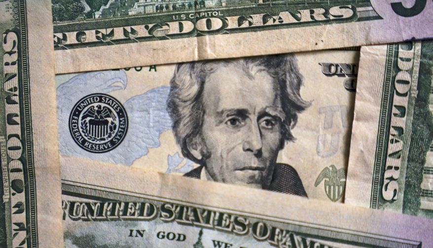 Photo of Andrew Jackson on a $20 bill is shown, Jan. 28, 2022, in Cleveland. Inflation is at a 40-year high. Stock prices are sinking. The Federal Reserve is making borrowing much costlier. Home sales are down, and mortgage rates are up. And the economy actually shrank in the first three months of this year. Is the United States at risk of enduring another recession, just two years after emerging from the last one? For now, even the more pessimistic economists don’t foresee any imminent downturn, at least not before next year. (AP Photo/Tony Dejak) ** FILE **
