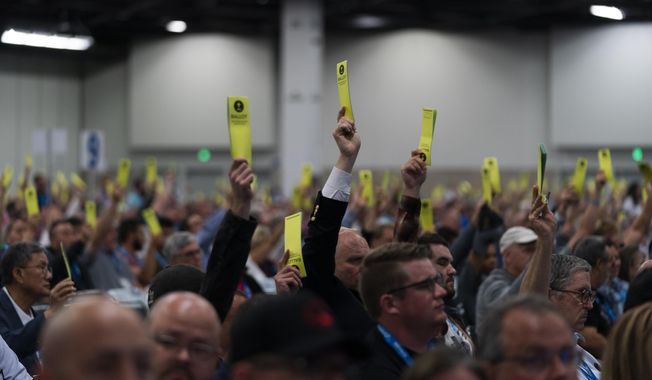 Attendees hold up their ballots during a session at the Southern Baptist Convention&#x27;s annual meeting in Anaheim, Calif., Tuesday, June 14, 2022. (AP Photo/Jae C. Hong)