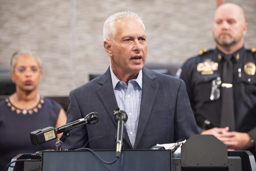 Duncanville Mayor Barry Gordon conducts a press conference about an incident when Duncanville Police Officers shot and killed an armed man outside of a children's summer camp, on June 13, 2022 in Duncanville, Texas. Behind Mayor Gordon is City Manager Aretha R. Ferrell-Benavides, left, and Assistant Chief of Police Matthew Stogner. (Ben Torres/The Dallas Morning News via AP)