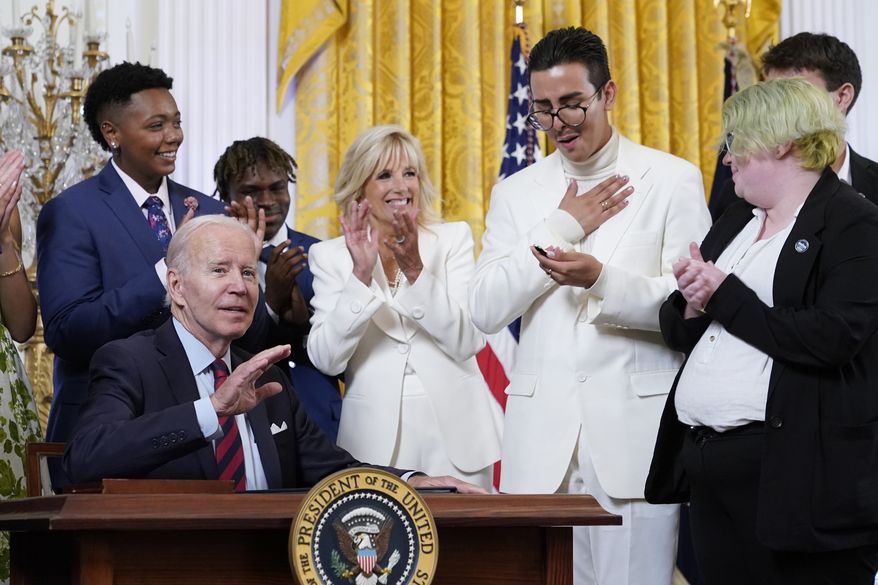 Youth activist Javier Gomez reacts after President Joe Biden handed him a pen he used to sign an executive order at an event to celebrate Pride Month in the East Room of the White House, Wednesday, June 15, 2022, in Washington. (AP Photo/Patrick Semansky)