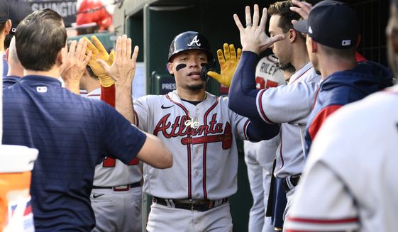 Atlanta Braves&#39; William Contreras, center, celebrates in the dugout after he scored on a single by Michael Harris II during the fourth inning of a baseball game against the Washington Nationals, Wednesday, June 15, 2022, in Washington. (AP Photo/Nick Wass)