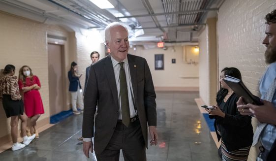 Sen. John Cornyn, R-Texas, arrives to meet with Sen. Chris Murphy, D-Conn., and Sen. Kyrsten Sinema, D-Ariz., arrive for more bipartisan talks on how to rein in gun violence, at the Capitol in Washington, Wednesday, June 15, 2022. Democratic and Republican negotiators have already reached a broad agreement but still need to convert that accord into legislation, in hopes that Congress could approve it before leaving for its July 4 recess. (AP Photo/J. Scott Applewhite)