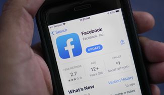 The Facebook app is shown on a smartphone, in Surfside, Fla., on April 23, 2021. (AP Photo/Wilfredo Lee) **FILE**