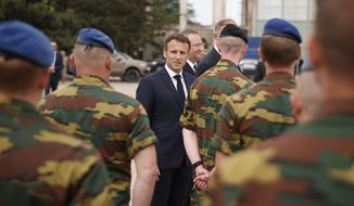 French President Emmanuel Macron meets Belgian NATO forces at the Mihail Kogalniceanu Air Base, near Constanta, Romania, Wednesday, June 15 2022. France has around 500 soldiers deployed in Romania and has been a key player in NATO&#39;s bolstering of forces on the alliance&#39;s eastern flank following Russia&#39;s invasion of Ukraine on Feb. 24. (Yoan Valat, Pool via AP)