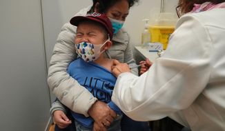 A boy receives a dose of China&#39;s Sinovac COVID-19 coronavirus vaccine at a community vaccination center in Hong Kong on Feb. 25, 2022. U.S. government advisers met Wednesday, June 15, 2022 to decide whether to endorse COVID-19 shots for babies, toddlers and preschoolers, moving the nation closer to vaccinations for all ages. According to the World Health Organization, 12 countries are vaccinating kids under 5. (AP Photo/Kin Cheung, File)