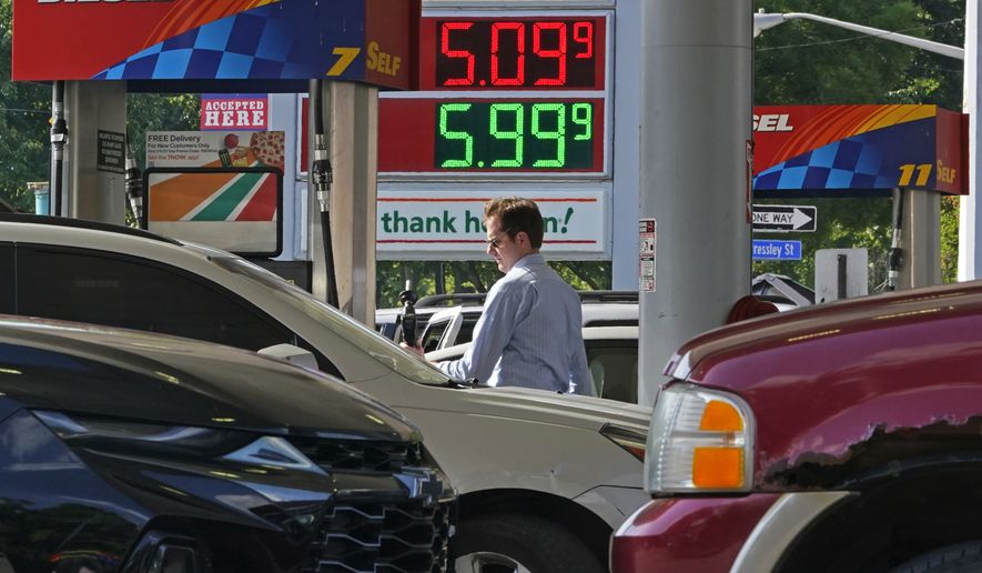 A man pumps gas at a mini-mart in Pittsburgh on Wednesday, June 15, 2022. (AP Photo/Gene J. Puskar)
