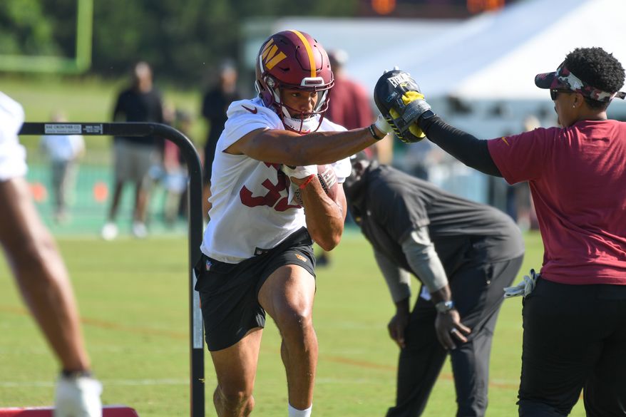 Washington Commanders running back Reggie Bonofon (38) doing drills with Assistant Running Backs Coach Jennifer King during veteran minicamp at the team's Inova Sports and Performance Center in Ashburn, VA, June 15, 2022. (Photo by All-Pro Reels)