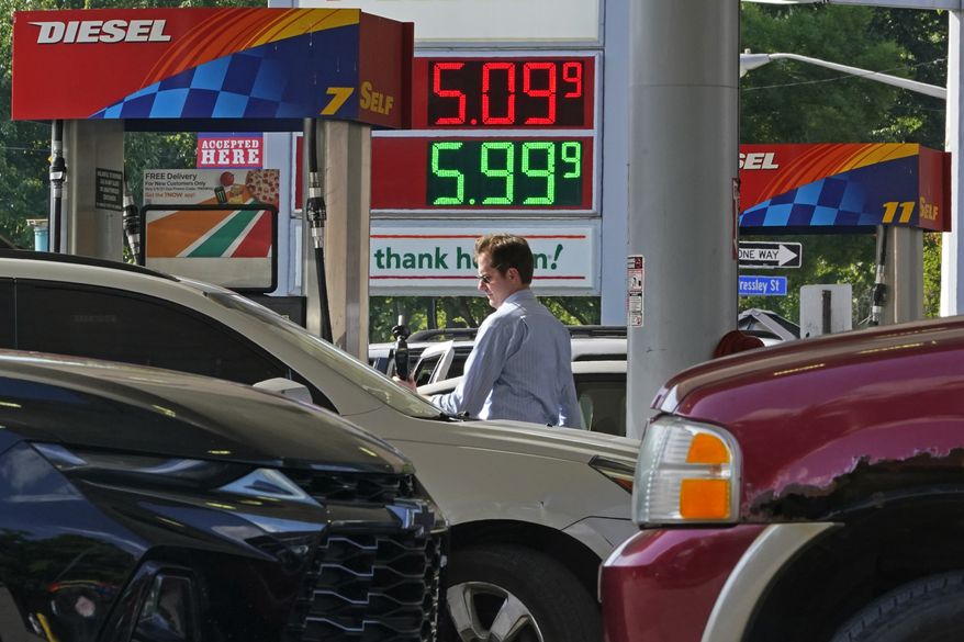A man pumps gas at a mini-mart in Pittsburgh on Wednesday, June 15, 2022. (AP Photo/Gene J. Puskar)