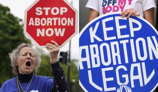 A woman holds a sign saying &amp;quot;stop abortion now,&amp;quot; at a protest outside of the U.S. Supreme Court in Washington on May 5, 2022, left, and another woman holds a sign during a news conference for reproductive rights in response to the leaked draft of the Supreme Court&#39;s opinion to overturn Roe v. Wade, in West Hollywood, Calif., on March 3, 2022. For families divided along red house-blue house lines, summer&#39;s slate of reunions, group trips and weddings poses another exhausting round of navigating divides. The season opens at a time of conflict fatigue. Pandemic restrictions have melted away but gun control, the fight for reproductive rights, the Jan. 6 insurrection hearings, the bite of high inflation and a range of other issues prevail. (AP Photo)