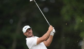 Brooks Koepka watches his shot on the 11th hole during the second round of the U.S. Open golf tournament at The Country Club, Friday, June 17, 2022, in Brookline, Mass. (AP Photo/Robert F. Bukaty)