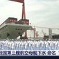 In this image taken from video footage run by China&#39;s CCTV, sailors line up in front of China&#39;s third aircraft carrier christened Fujian before its launching ceremony at a dry dock in Shanghai on Friday, June 17, 2022. State media reported that China on Friday launched its third aircraft carrier, the first such ship to be both designed and built entirely within the country. Chinese characters on screen reads &quot;Our country&#39;s third aircraft carrier launched into water, named Fujian.&quot; (CCTV via AP)