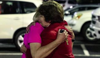 Church members console each other after a shooting at the Saint Stevens Episcopal Church on Thursday, June 16, 2022, in Vestavia, Ala. (AP Photo/Butch Dill)