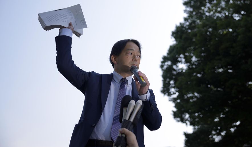 Izutaro Managi, a lawyer for the plaintiffs, speaks to plaintiffs and their supporters after hearing the decision of the Tokyo Supreme Court, Friday, June 17, 2022, in Tokyo. Japan’s top court on Friday ruled that the government was not liable for the 2011 Fukushima nuclear crisis, dismissing thousands of evacuees's demands that the state, not just the utility, should pay compensation for the damages inflicted to their lives. (AP Photo/Eugene Hoshiko)
