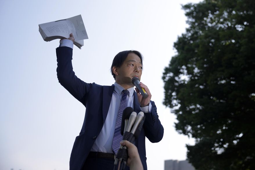 Izutaro Managi, a lawyer for the plaintiffs, speaks to plaintiffs and their supporters after hearing the decision of the Tokyo Supreme Court, Friday, June 17, 2022, in Tokyo. Japan’s top court on Friday ruled that the government was not liable for the 2011 Fukushima nuclear crisis, dismissing thousands of evacuees's demands that the state, not just the utility, should pay compensation for the damages inflicted to their lives. (AP Photo/Eugene Hoshiko)