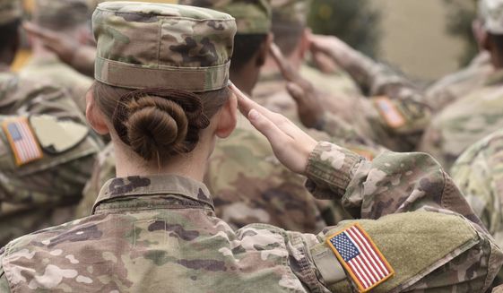American soldiers salute. US Army. Photo credit Bumble Dee via Shutterstock.