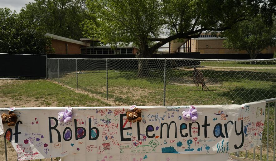 A sign with encouraging messages hangs at a memorial at Robb Elementary School created to honor the victims killed in the recent school shooting, Thursday, June 9, 2022, in Uvalde, Texas. The Texas elementary school where a gunman killed 19 children and two teachers has long been a part of the fabric of the small city of Uvalde, a school attended by generations of families, and where the spark came that led to Hispanic parents and students to band together to fight discrimination over a half-century ago. (AP Photo/Eric Gay)