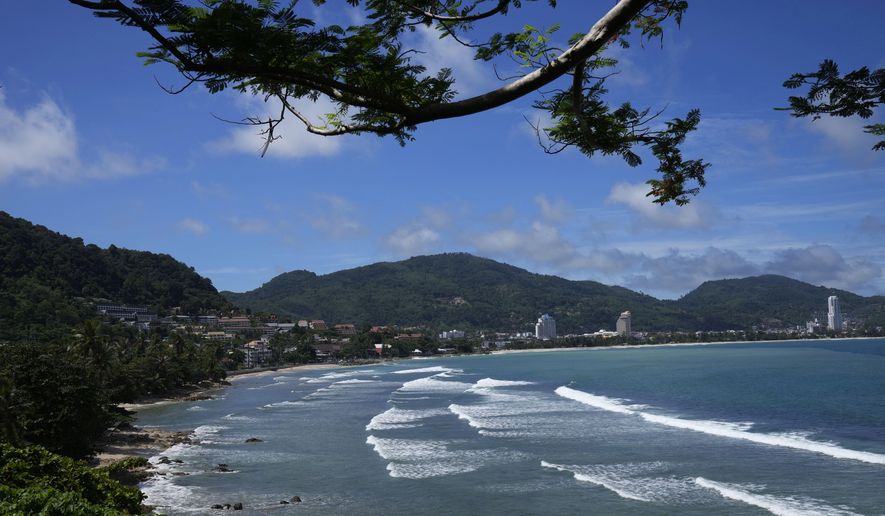 Waves break on the empty tourist beach of Patong on Phuket, southern Thailand on June 29, 2021. Thai authorities say that on July 1, 2022, they are lifting the need for arriving foreign visitors to register online to get pre-approval for entry. (AP Photo/Sakchai Lalit, File)