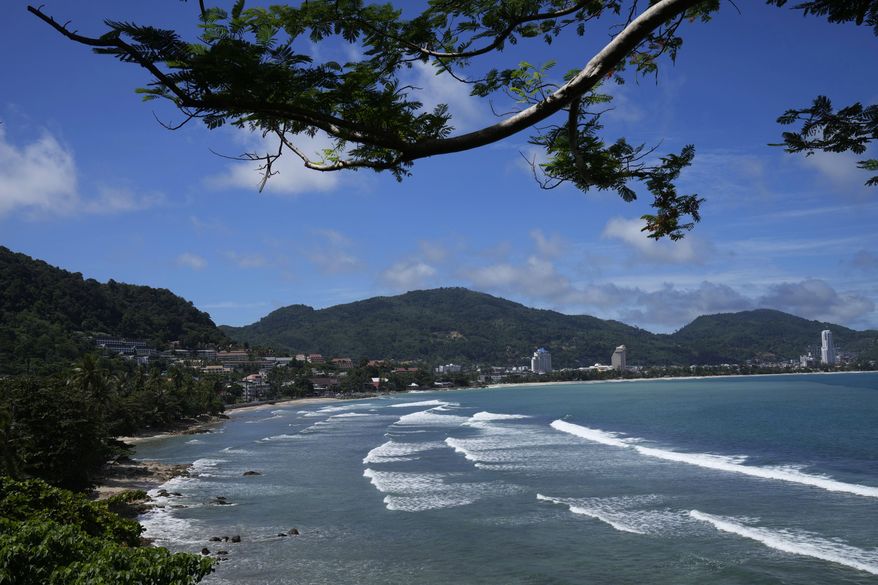 Waves break on the empty tourist beach of Patong on Phuket, southern Thailand on June 29, 2021. Thai authorities say that on July 1, 2022, they are lifting the need for arriving foreign visitors to register online to get pre-approval for entry. (AP Photo/Sakchai Lalit, File)