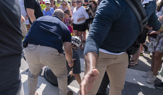 President Joe Biden is helped by Secret Service agents after falling from his bike as he stopped to greet a crowd on a trail at Gordons Pond in Rehoboth Beach, Del., Saturday, June 18, 2022. (AP Photo/Manuel Balce Ceneta)