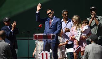 Former Washington Nationals player Ryan Zimmerman, center, waves during his jersey retirement ceremony before a baseball game between the Nationals and the Philadelphia Phillies, Saturday, June 18, 2022, in Washington. (AP Photo/Nick Wass)