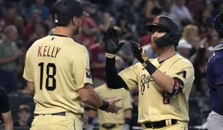 Arizona Diamondbacks&#39; Jordan Luplow celebrates with teammate Carson Kelly (18) after hitting a two-run home run against the Minnesota Twins in the first inning during a baseball game, Friday, June 17, 2022, in Phoenix. (AP Photo/Rick Scuteri)