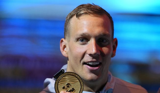 Caeleb Dressel of the United States poses with his medal after winning the Men 50m Butterfly final at the 19th FINA World Championships in Budapest, Hungary, Sunday, June 19, 2022. (AP Photo/Petr David Josek) **FILE**