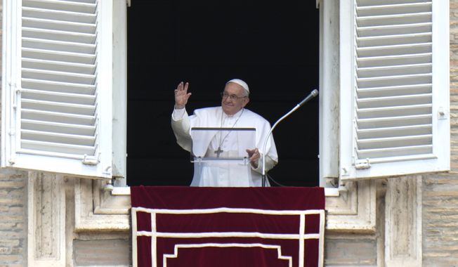 Pope Francis waves during the Angelus noon prayer from the window of his studio overlooking St.Peter&#x27;s Square, at the Vatican, Sunday, June 19, 2022. (AP Photo/Alessandra Tarantino)