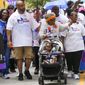 Opal Lee pushes one of her great granddaughters in a stroller as she waves to musicians playing along the route during the 2022 Opal&#39;s Walk for Freedom on Saturday, June 18, 2022, in Fort Worth. Lee, often referred to as the &amp;quot;Grandmother of Juneteenth&amp;quot; led her annual two-and-a-half-mile walk, representing the number of years after the Emancipation Proclamation before enslaved people in Texas learned they were free. (Smiley N. Pool/The Dallas Morning News via AP)
