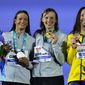 Silver medalist Katie Grimes of the United States, gold medalist Katie Ledecky of the United States and bronze medalist Lani Pallister of Australia, from left to right, pose on the podium of the Women 1500m Freestyle final at the 19th FINA World Championships in Budapest, Hungary, Monday, June 20, 2022. (AP Photo/Petr David Josek) **FILE**