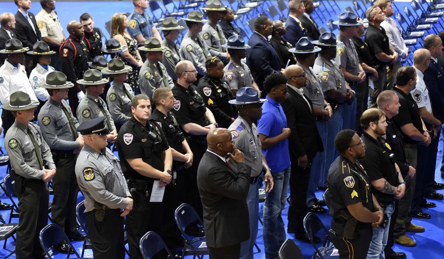 Law enforcement from across Mississippi gather in the Meridian High School gymnasium for a memorial service for Meridian Police Department Officer Kennis Croom in Meridian, Miss., Thursday, June 16, 2022. Croom was killed during a domestic disturbance call on June 9. (Thomas Howard/The Meridian Star via AP)