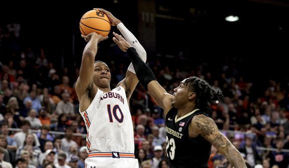 Auburn forward Jabari Smith (10) shoots a 3-pointer over Vanderbilt guard Jamaine Mann (23) during the second half of an NCAA college basketball game Feb. 16, 2022, in Auburn, Ala. Smith is one of the top forwards in the upcoming NBA draft. (AP Photo/Butch Dill, File) **FILE**