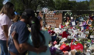 People visit a memorial at Robb Elementary School in Uvalde, Texas, on June 2, 2022, to pay their respects to the victims killed in a school shooting. A legislative committee investigating the deadly shooting at the Texas elementary school is set to hear more testimony from law enforcement officers on Monday, June 20, 2022. (AP Photo/Jae C. Hong, File)
